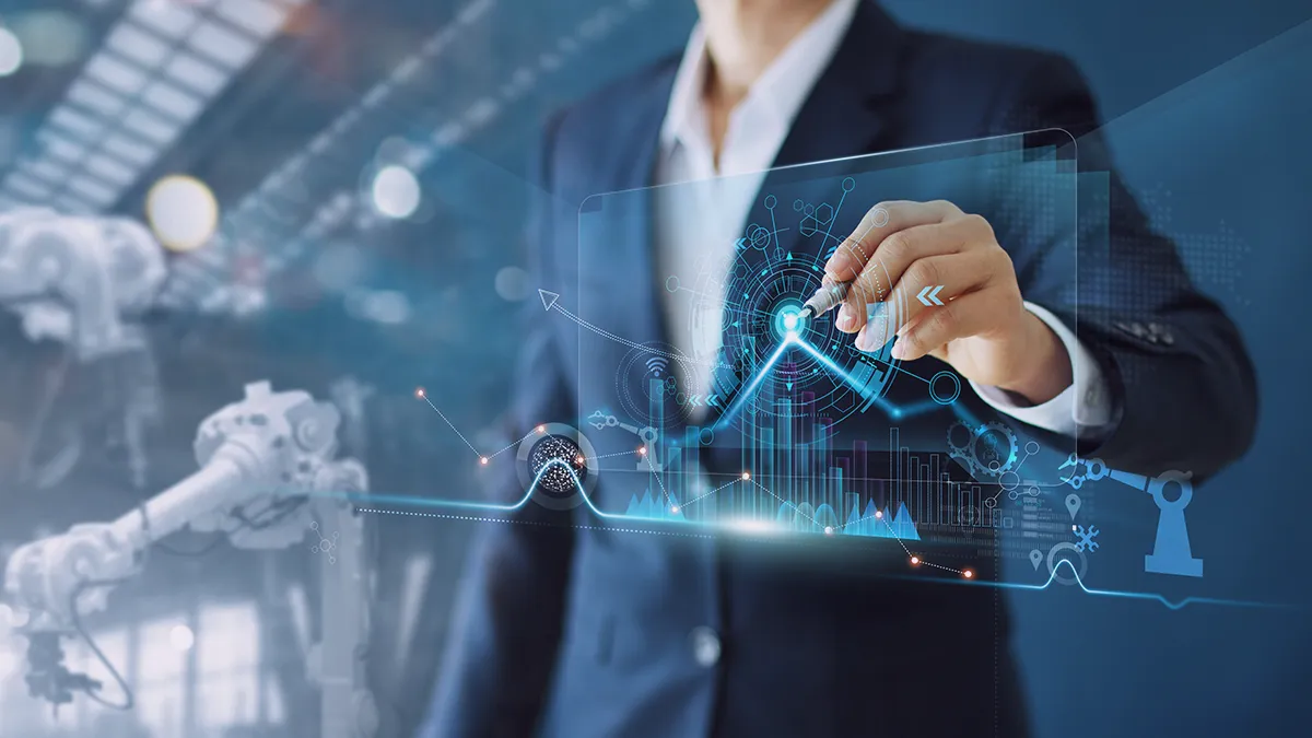 Osoba w garniturze biznesowym wchodzi w interakcję z futurystycznym interfejsem holograficznym wyświetlającym różne wykresy i diagramy technologiczne. Tło zawiera elementy przemysłowe, takie jak koła zębate i ramiona robotów, sugerujące zaawansowane środowisko produkcyjne lub spawalnicze. Ten obraz wizualnie przedstawia historię sukcesu optymalizacji kosztów Azure firmy ESAB, podkreślając integrację zaawansowanej technologii w branży spawalniczej.