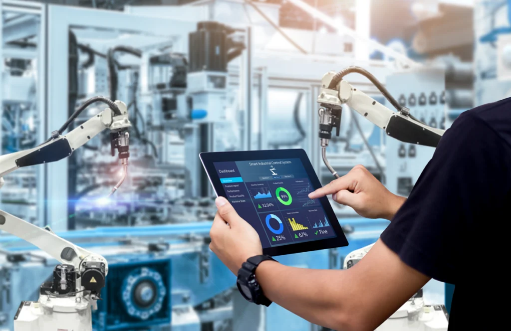 Production hall _ a man looks at a tablet screen and analyzes graphs related to energy consumption