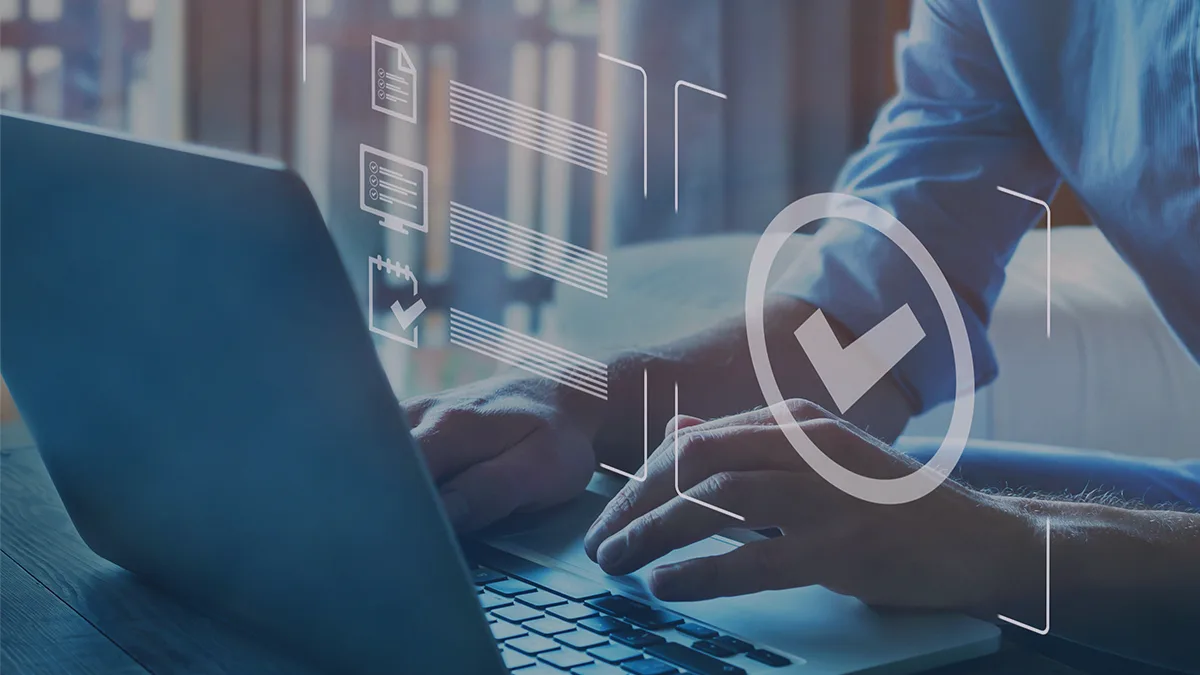 A photo showing hands typing on a laptop keyboard in an office environment, above the keyboard float symbols of folders the person is working on; the graphic is taken as the cover of a blog post on third-party code testing - a service of having a third-party team test the correctness of code, the article is by an expert from Transition Technologies PSC