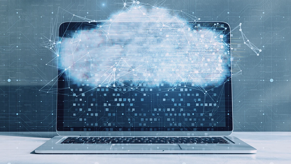 A graphic image featuring a laptop with a cloud of digital points and lines emanating from its screen, set against a dark background with circuit-like designs. This suggests a theme of technological advancement and the strategic decision-making process involved in adopting cloud-native solutions for businesses.