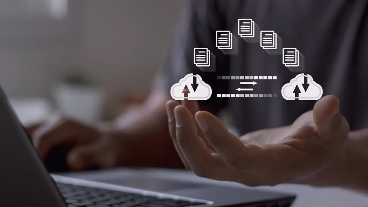 Graphic banner titled ‘Success Story: How cloud microservices improved data extraction process from Windchill for luxury goods manufacturer.’ The image features an outstretched hand with icons representing cloud computing and data transfer floating above it. These icons include clouds connected with dotted lines to database symbols and document icons, indicating seamless integration of services.