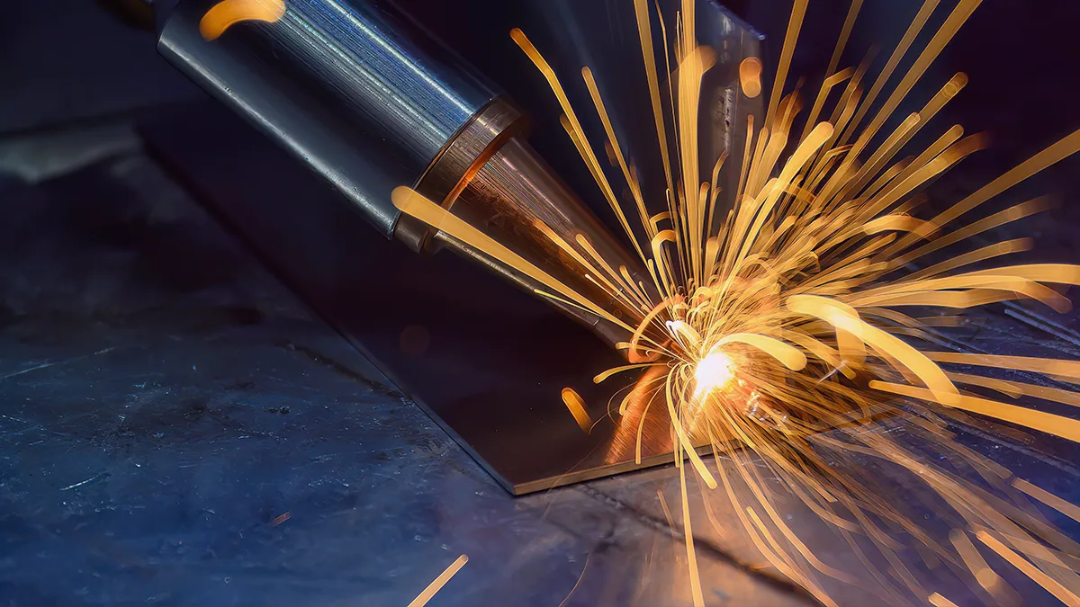 Graphic illustrating an article on the Transition Technologies PSC blog, showing a close-up photo of sparks during welding; colors – dark navy blue background, bright sparks. Photo displayed in a tile leading to an article titled: Mari4_YARD project results: manual laser welding with a guide on HoloLens 2