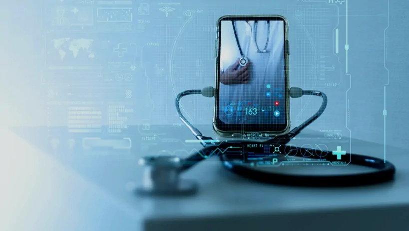 A smartphone displaying a doctor holding a stethoscope is connected to a real stethoscope, symbolizing telemedicine and digital healthcare technology.