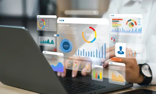 Person using a laptop with floating data charts and analytics visuals.