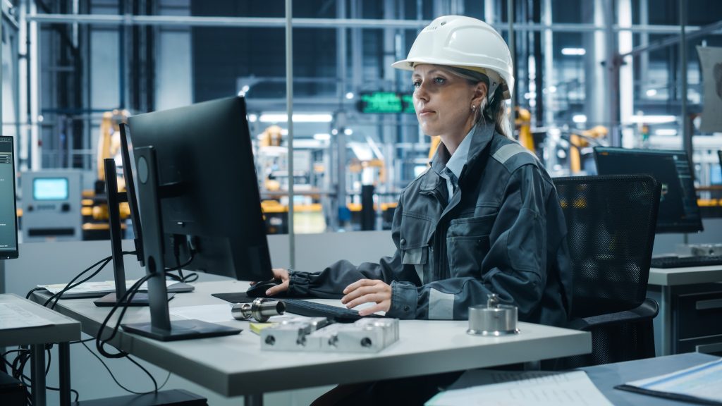 additional image: a woman working with a computer in a factory
