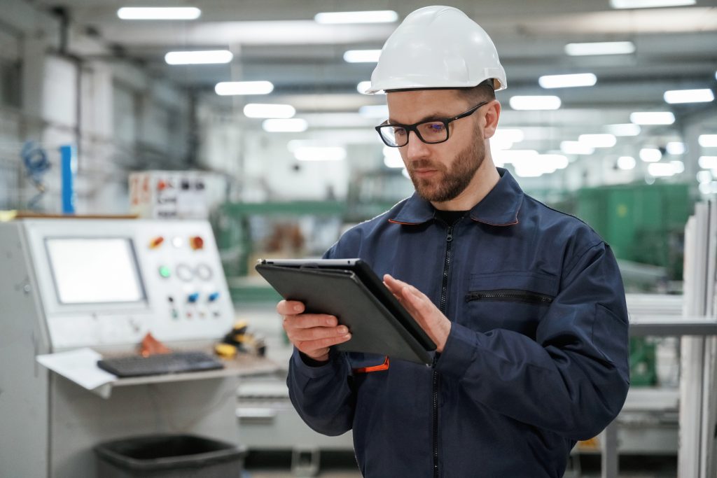 additional image, blogpost, a man configuring something on a tablet in a factory