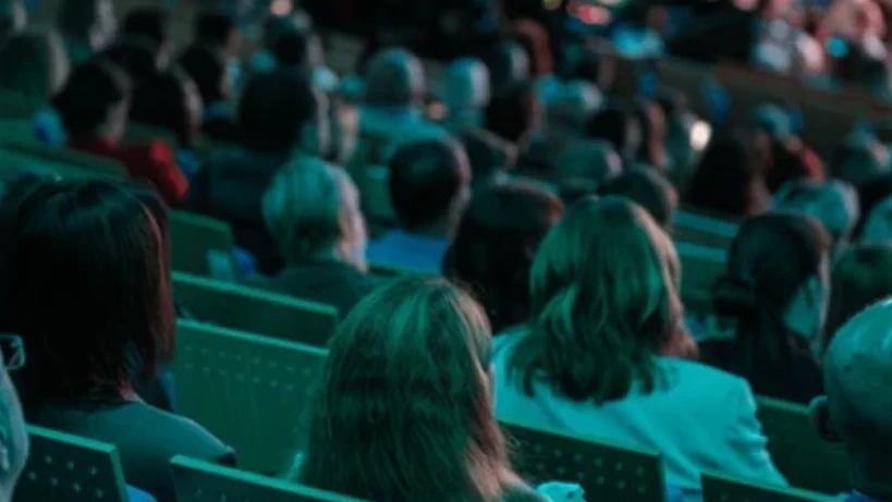 People sitting and watching a presentation