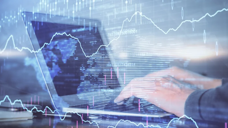 Person typing on a laptop with overlaid charts and data visualizations – representing data analysis and predictive analytics