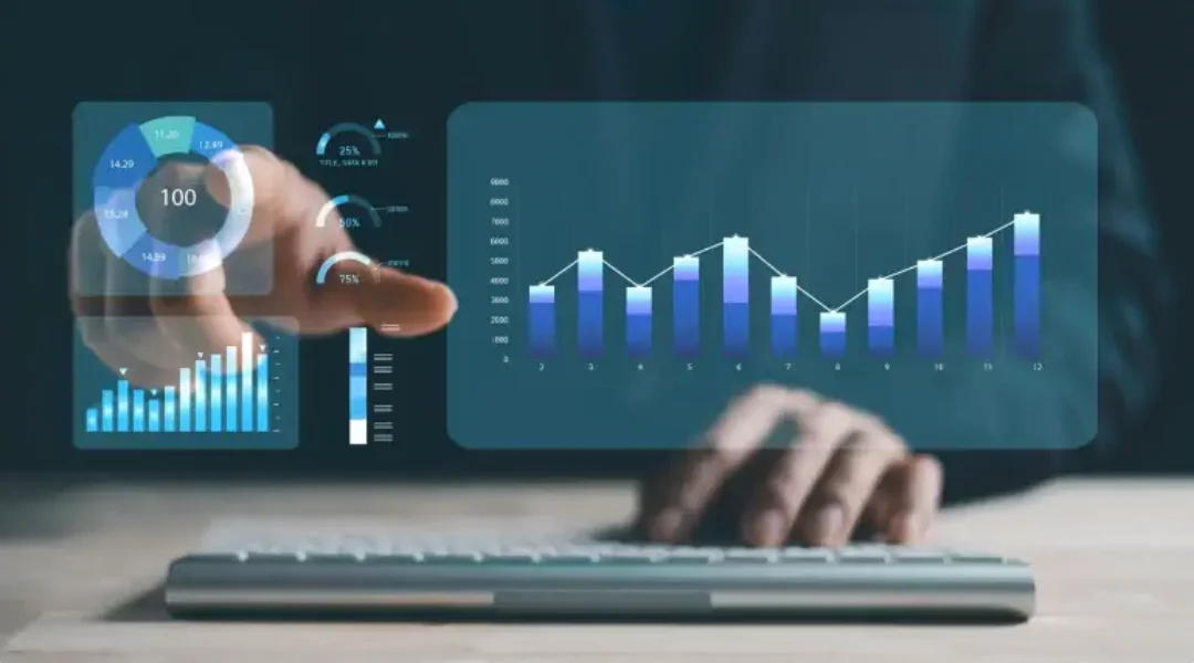 Data analytics visualization with bar and pie charts on a virtual touchscreen above a keyboard.