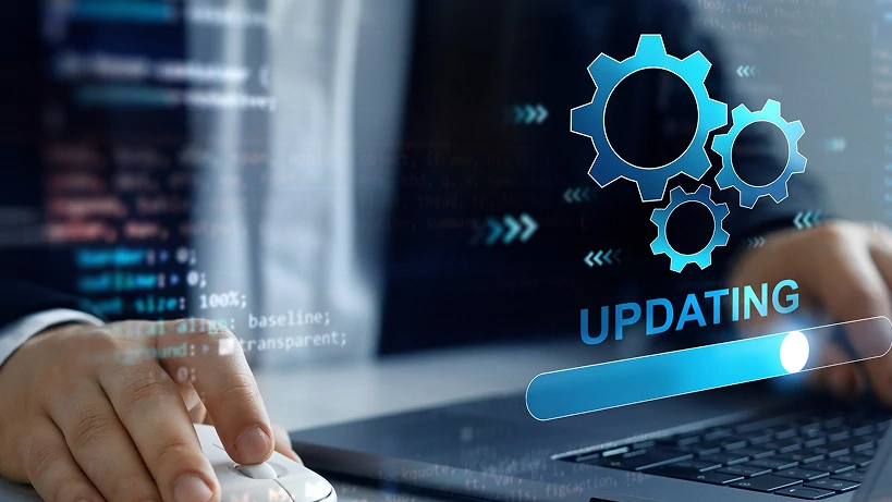 Ein Profi, der einen Laptop mit einer digitalen Schnittstelle verwendet, auf der ein „Aktualisierung“-Fortschrittsbalken und miteinander verbundene Zahnräder angezeigt werden, die ein Software-Upgrade oder eine Systemverbesserung symbolisieren. Der Hintergrund zeigt Codezeilen, die technologische Fortschritte und nahtlose Plattformverbesserungen hervorheben