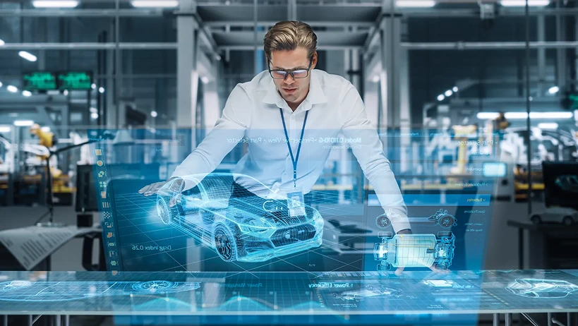 Ingenieur analysiert ein holografisches 3D-Modell eines Autos in einer intelligenten Fabrik, das cloudbasiertes PLM (Product Lifecycle Management) und digitale Zwillingstechnologie darstellt.